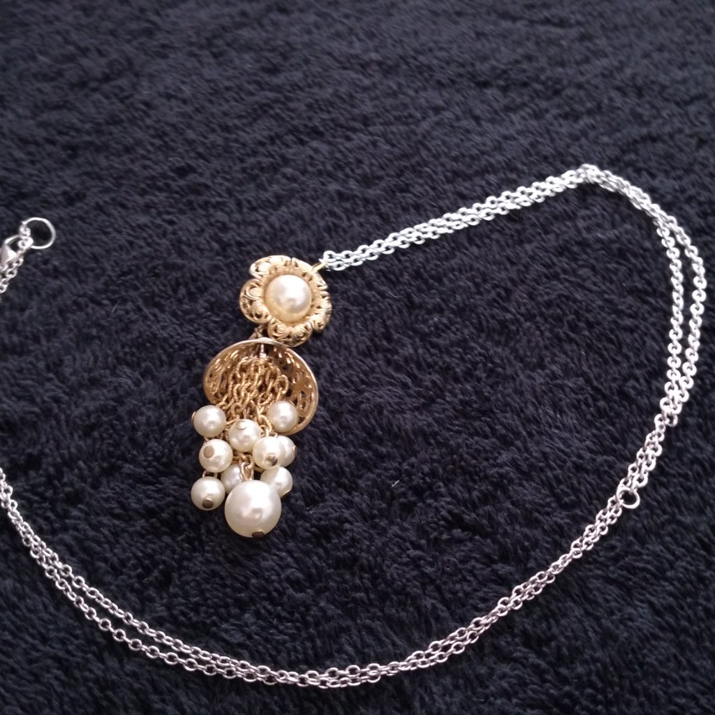 The Golden Pearls With Goldtone Carrage And Chain
